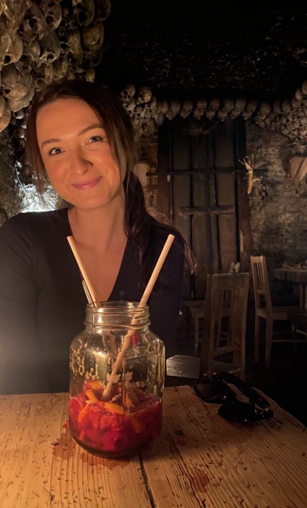 Kaitlyn in the medieval tavern in prague with a lemonade drink