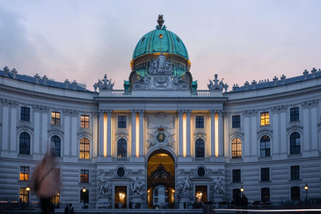 a large building with a dome and a clock in Austria, Vienna