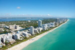 aerial view of Miami city buildings, beach, and blue water